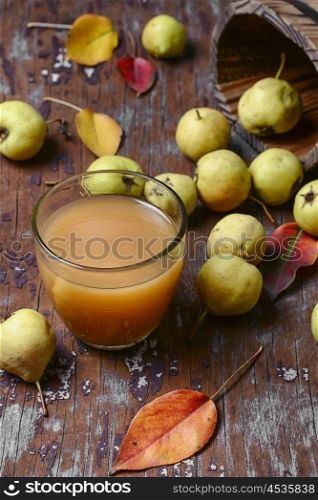 Juice with pear. Glass cup pear juice autumn pears scattered across the table