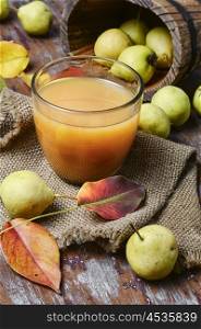 Juice with pear. Glass cup pear juice autumn pears scattered across the table