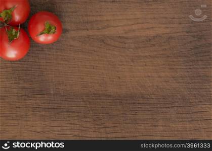 Juicy Cherry tomatoes on wooden background closeup