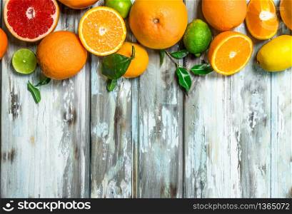 Juicy citrus with leaves. On wooden background. Juicy citrus with leaves.