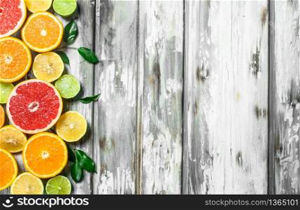 Juicy citrus with leaves. On wooden background. Juicy citrus with leaves.