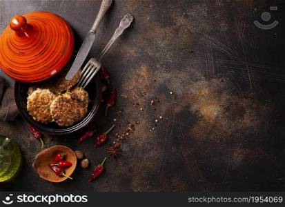 juicy delicious meat cutlets in bowl sprinkled with chili and other spices.
