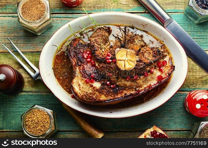 Juicy fried pork belly with spices, herbs and pomegranate.. Baked pork belly with herbs.