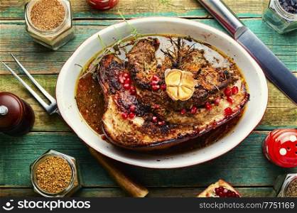 Juicy fried pork belly with spices, herbs and pomegranate.. Baked pork belly with herbs.