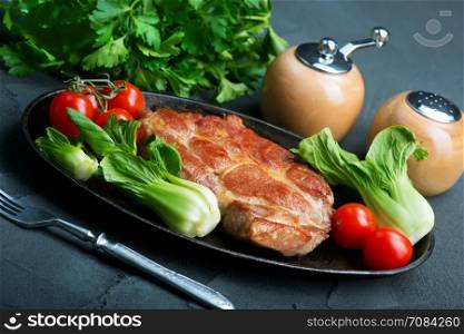 juicy fried steak on plate with salad