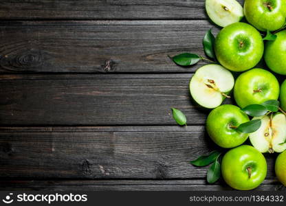 Juicy green apples with leaves. On wooden background.. Juicy green apples with leaves.