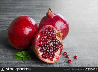 Juicy pomegranate fruit over wooden vintage table
