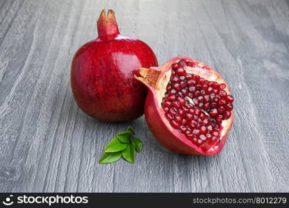 Juicy pomegranate fruit over wooden vintage table
