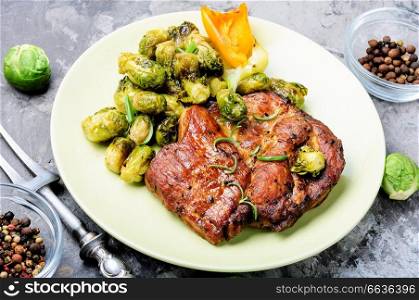 Juicy portions of grilled fillet steak served with roast vegetables.Fresh grilled meat.. Meat steak with vegetables