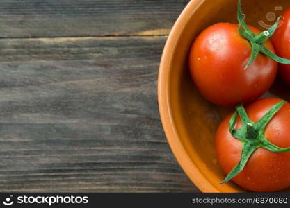 Juicy ripe red tomatoes on a wooden table