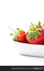 Juicy ripe red whole fresh home grown strawberries in a plain white ceramic bowl with attached green stalks for a healthy finger food snack or cooking and baking ingredient, copyspace on white
