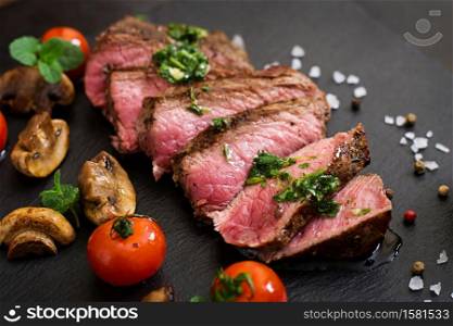 Juicy steak medium rare beef with spices and grilled vegetables.