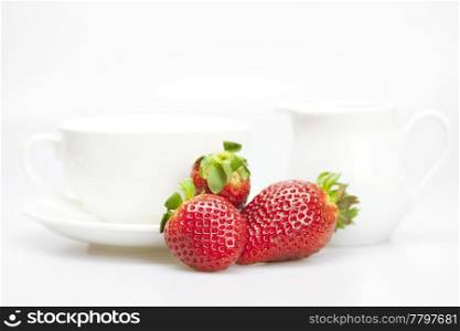 juicy strawberries and tableware isolated on white
