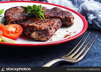 juicy veal steak. Beef with tomato grilled on a plate for dinner