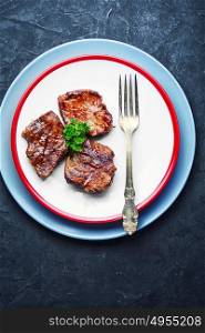juicy veal steak. Three grilled steak of beef on the plate