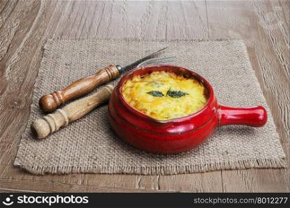 julienne with mushrooms, cream and cheese on wooden background