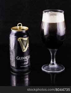 July 6, 2016: Guinness beer can and glass over black reflecting background. Guinness is an Irish dry stout produced by Diageo that originated in the brewery of Arthur Guinness at St. James&rsquo;s Gate, Dublin. Guinness is one of the most successful beer brands worldwide