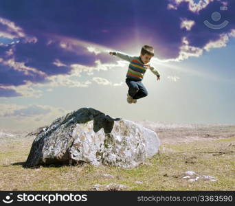 Jumping boy from big rock