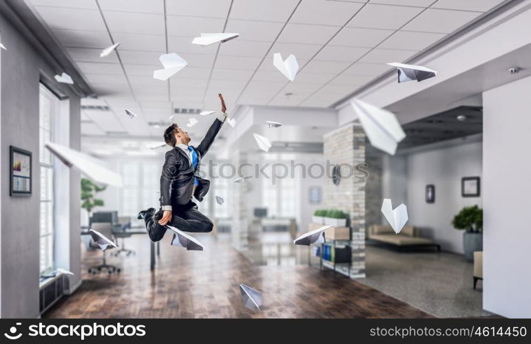 Jumping businessman in office. Funny jumping businessman in modern 3D rendering interior. Mixed media