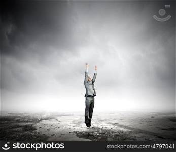 Jumping businessman. Young businessman jumping up trying to reach goal