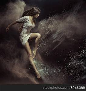 Jumping dancer in full of dust place