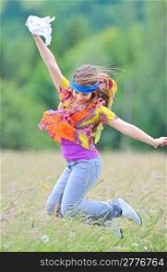 Jumping girl against summer meadow