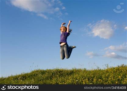 jumping girl on the green meadow