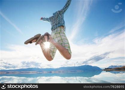 Jumping man in blue sky