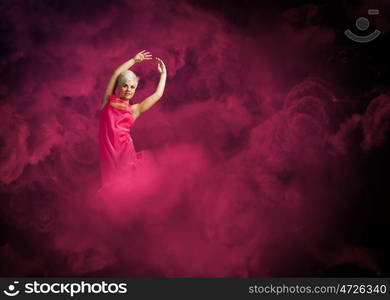 Jumping woman. Young attractive woman in pink dress jumping high