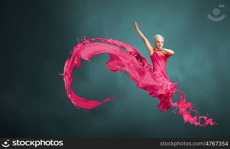 Jumping woman. Young attractive woman in pink dress jumping high