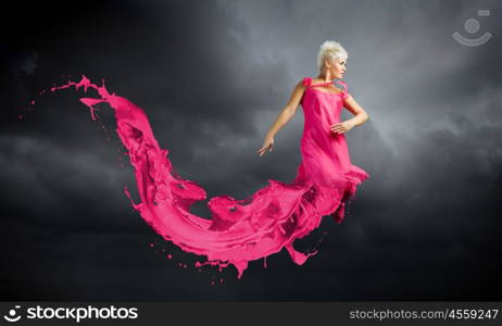 Jumping woman. Young attractive woman in red dress jumping high