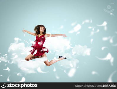 Jumping woman. Young attractive woman in red dress jumping high