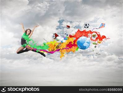 Jumping woman. Young woman dancer in green suit jumping high