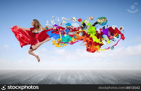 Jumping woman. Young woman dancer in red dress jumping high