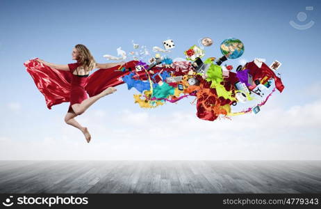 Jumping woman. Young woman dancer in red dress jumping high