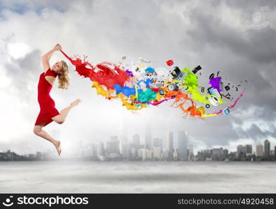 Jumping woman. Young woman dancer in red dress jumping high