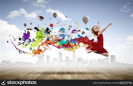 Jumping woman. Young woman dancer in red dress jumping high