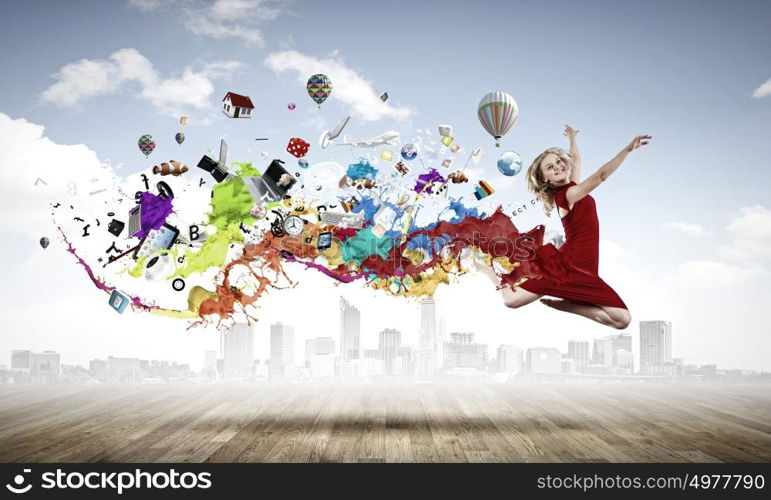 Jumping woman. Young woman dancer in red dress jumping high