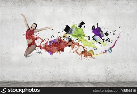 Jumping woman. Young woman dancer in red suit jumping high