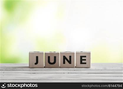 June sign on wooden blocks in the nature