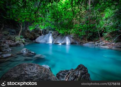 Jungle landscape with flowing turquoise water of Erawan cascade waterfall at deep tropical rain forest. National Park Kanchanaburi, Thailand