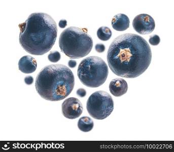 Juniper berries in the shape of a heart on a white background.. Juniper berries in the shape of a heart on a white background