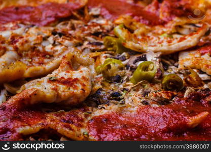 Junk fast food italian cuisine concept. Closeup of hot pizza. Delicious crusty unhealthy spicy meal.. Closeup of hot pizza.