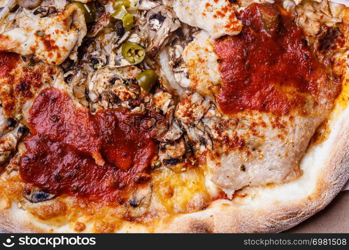 Junk fast food italian cuisine concept. Closeup of hot pizza. Delicious crusty unhealthy spicy meal.. Closeup of hot pizza.