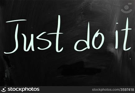 ""Just Do It" handwritten with white chalk on a blackboard"