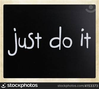 ""Just Do It" handwritten with white chalk on a blackboard"