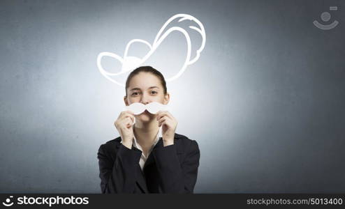 Just like man. Happy cute girl trying male paper mustache