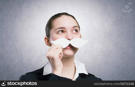 Just like man. Happy cute girl trying male paper mustache