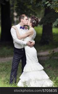Just married couple kissing in the park&#xA;