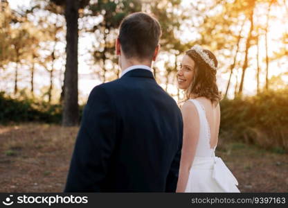 Just married couple looking at each other on a forest